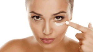 imagem de uma mulher aplicando creme para olheiras