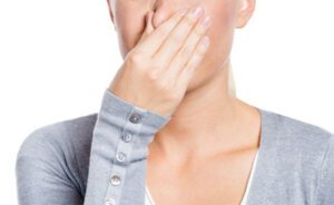 Pessoa tapando o nariz